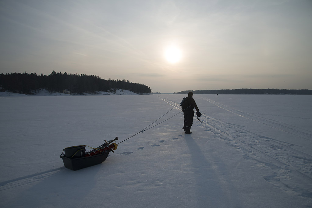 Out on sea ice, on our way to check the fish nets - Photo by Petri Ahlroth